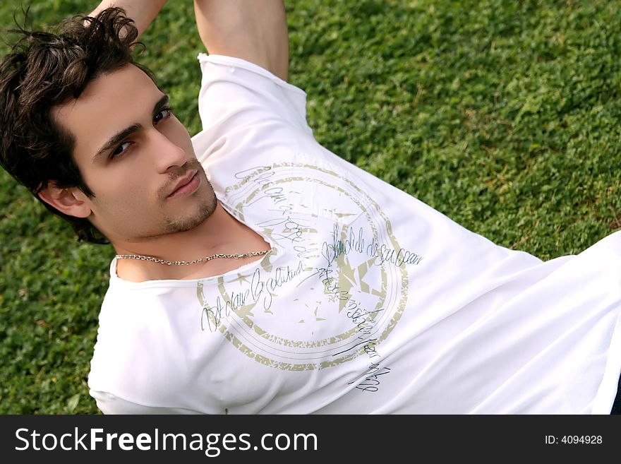 Young man lying on the grass relaxing