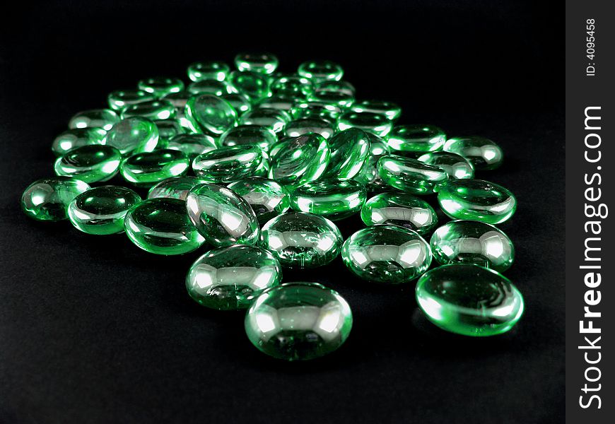 Green shiny stones isolated on black background