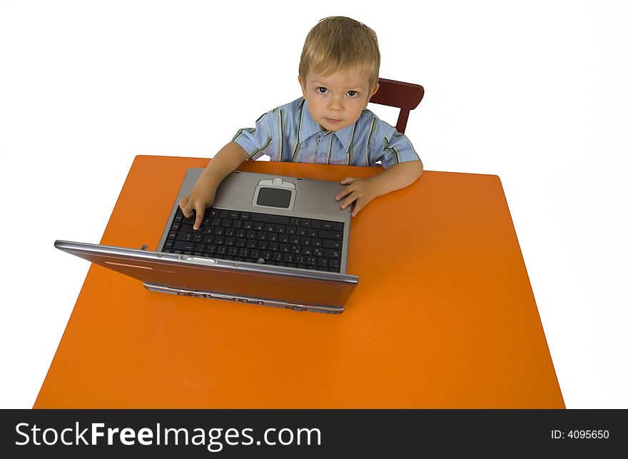 A child works with a laptop. A child works with a laptop.