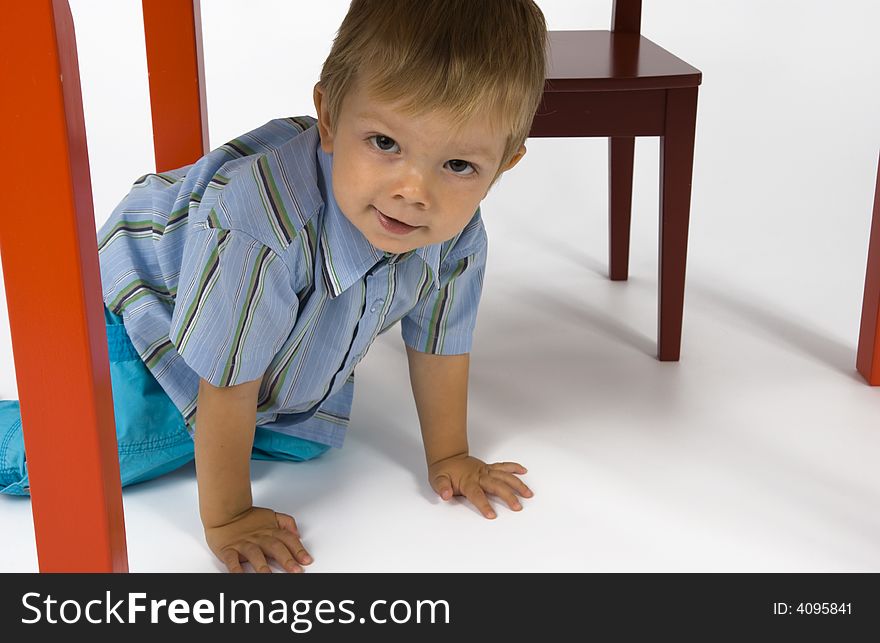 A child hides under the table. A child hides under the table.
