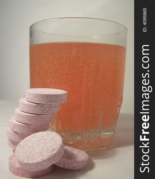 Isolated effervescent flu drink and tablets, white background