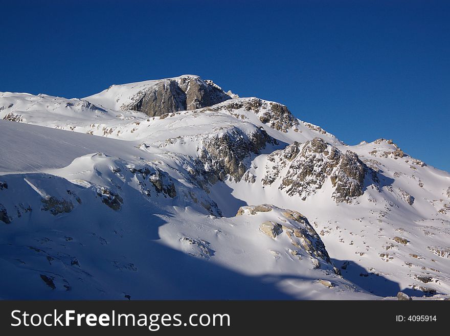 View on alpine snow winter mountains chain. Alps, France, Europe. View on alpine snow winter mountains chain. Alps, France, Europe.