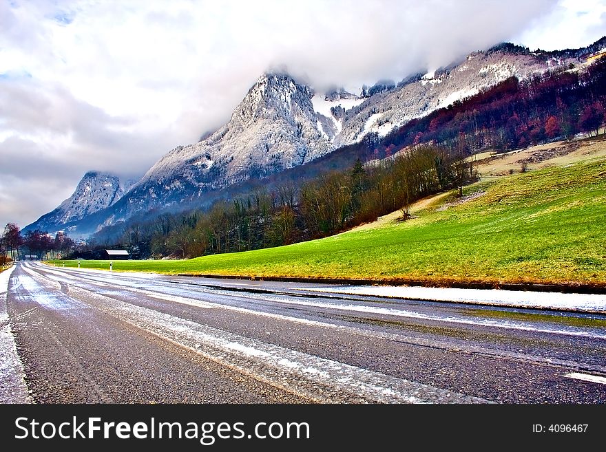 Road under foggy mountains. Switzerland. Road under foggy mountains. Switzerland