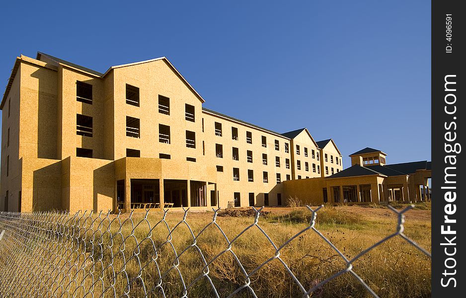 A commercial construction zone for apartments or a hotel against a blue sky background