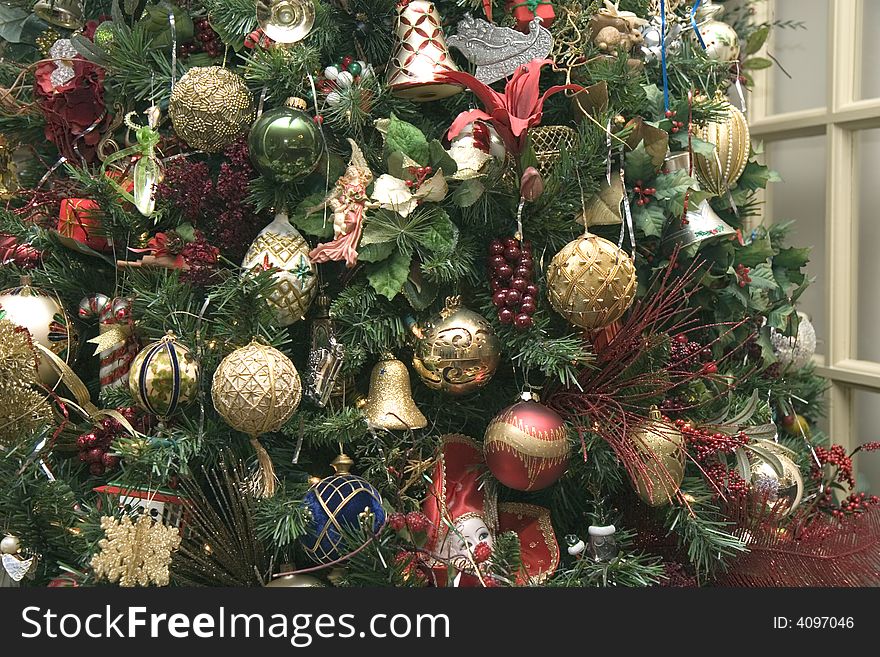 Gold ornaments on a christmas tree in the home