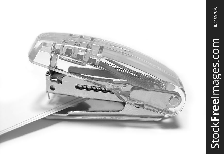 Transparent stapler on white background.