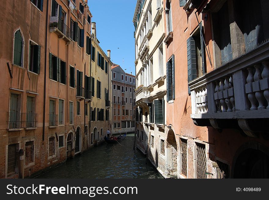 In beautiful venice, a gondola floating on a narrow canal. In beautiful venice, a gondola floating on a narrow canal