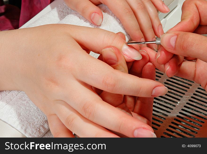 Master correcting the nails of a woman. Master correcting the nails of a woman