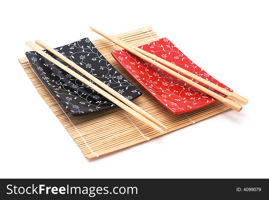 Black and red sushi set on bamboo mat