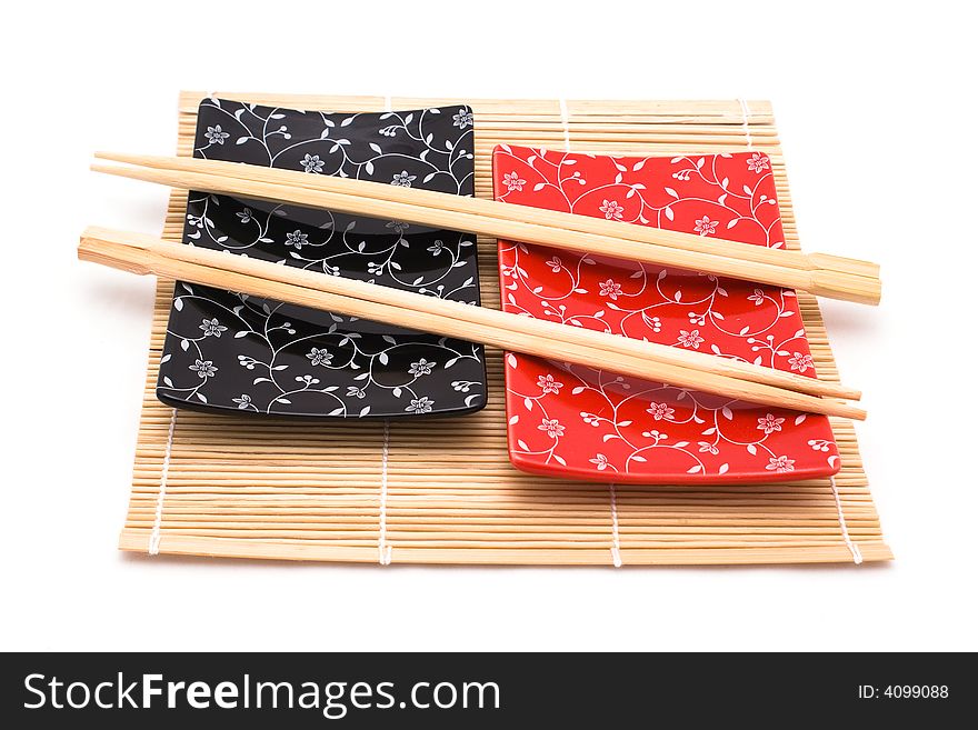 Black and red sushi set on bamboo mat