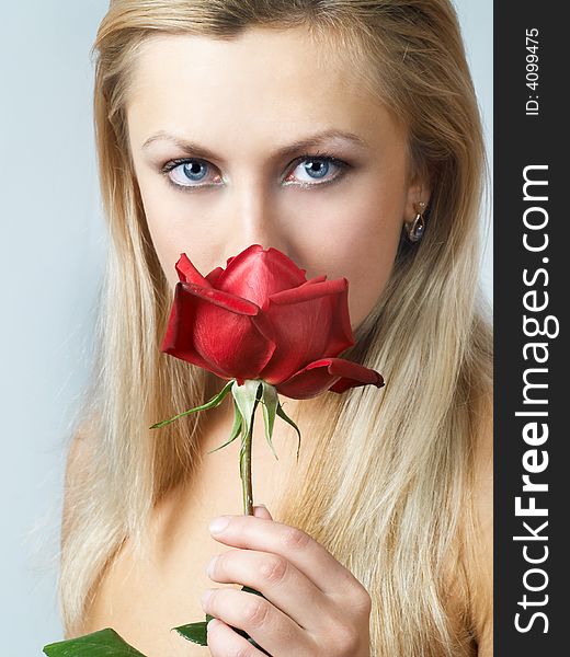 Blonde girl with blood red rose in hands. Blonde girl with blood red rose in hands