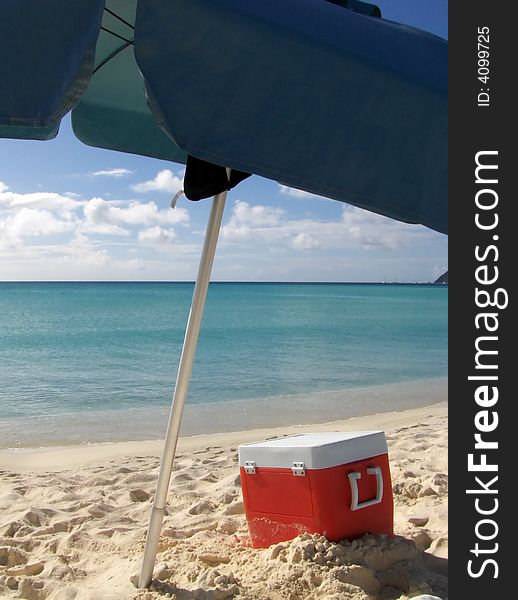 Box and umbrella on the beach