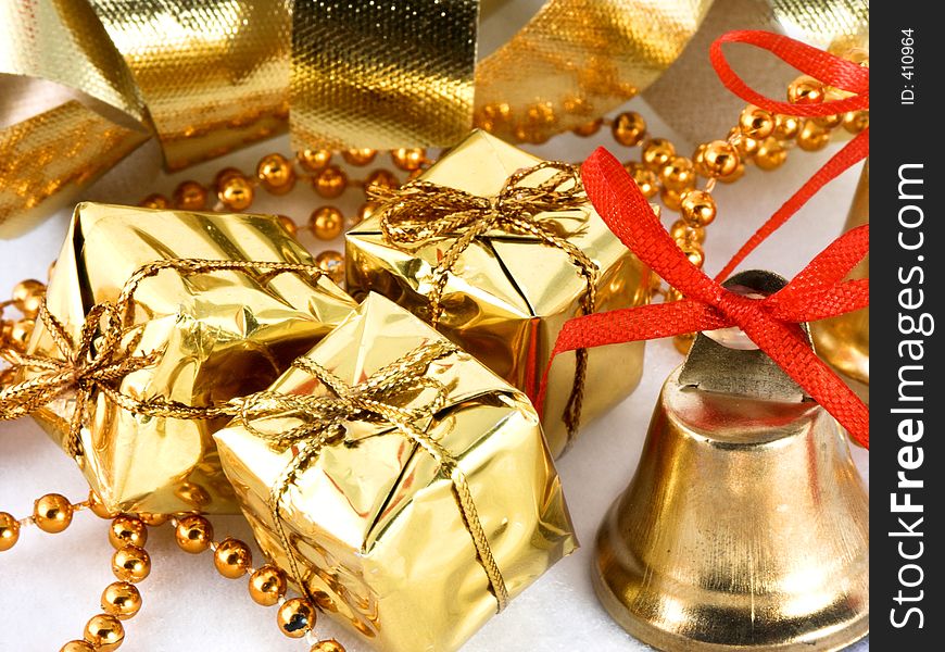 Golden presents and bell with ribbon background. Golden presents and bell with ribbon background