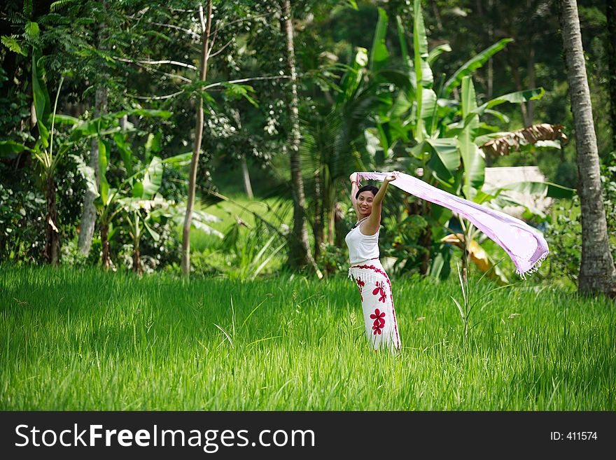 Happy Asian woman with her sarong at rice field. Happy Asian woman with her sarong at rice field