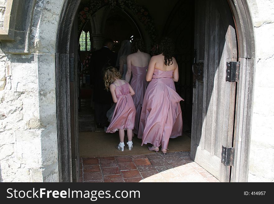 The youngest bridesmaid looks round at the bride. The youngest bridesmaid looks round at the bride