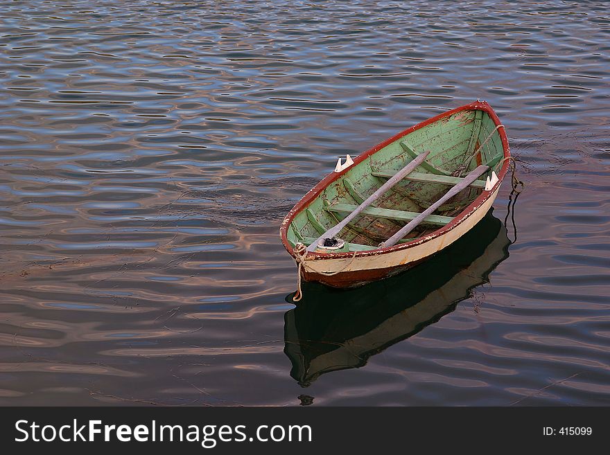 This old wooden norwegian fissinh boat looked quite lonely when i saw it lying there on the sea. i liked the space around it and the colors and painting on the boat, the reflection in the sea. A typical old fishingboat. This old wooden norwegian fissinh boat looked quite lonely when i saw it lying there on the sea. i liked the space around it and the colors and painting on the boat, the reflection in the sea. A typical old fishingboat.