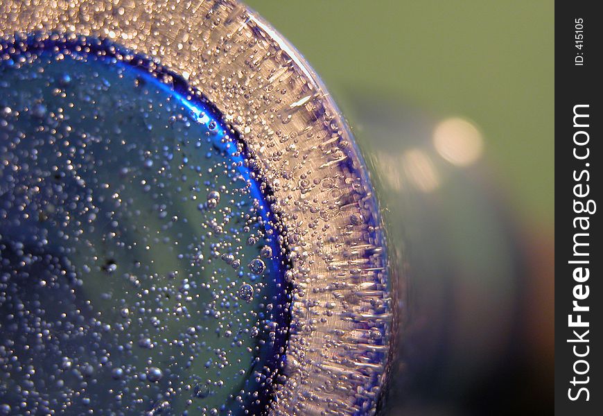 This is a macro picture of a flower vase in blue glass with loths og bubbles in it. What about seeing a vase from an other perspective?. This is a macro picture of a flower vase in blue glass with loths og bubbles in it. What about seeing a vase from an other perspective?