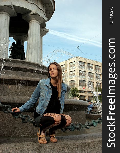 The girl at a fountain in city