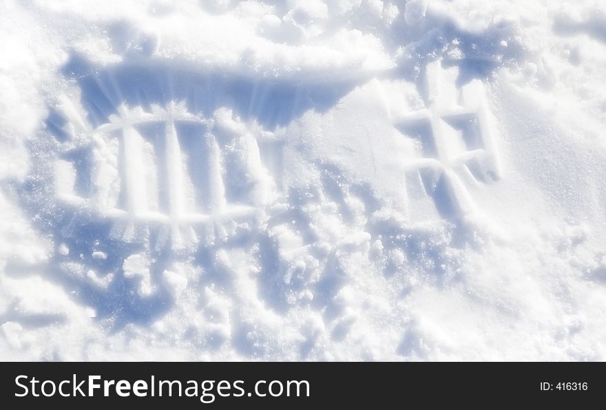 Boot track in the snow - blue tone and sparkle from ice crystals