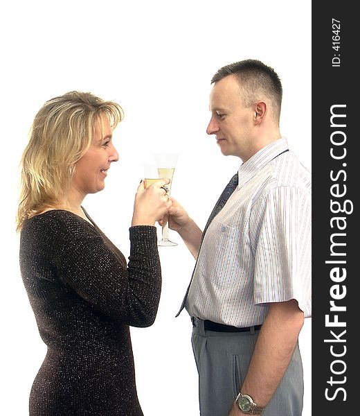 Young couple celebrating with two glasses of champagne over white background. Young couple celebrating with two glasses of champagne over white background