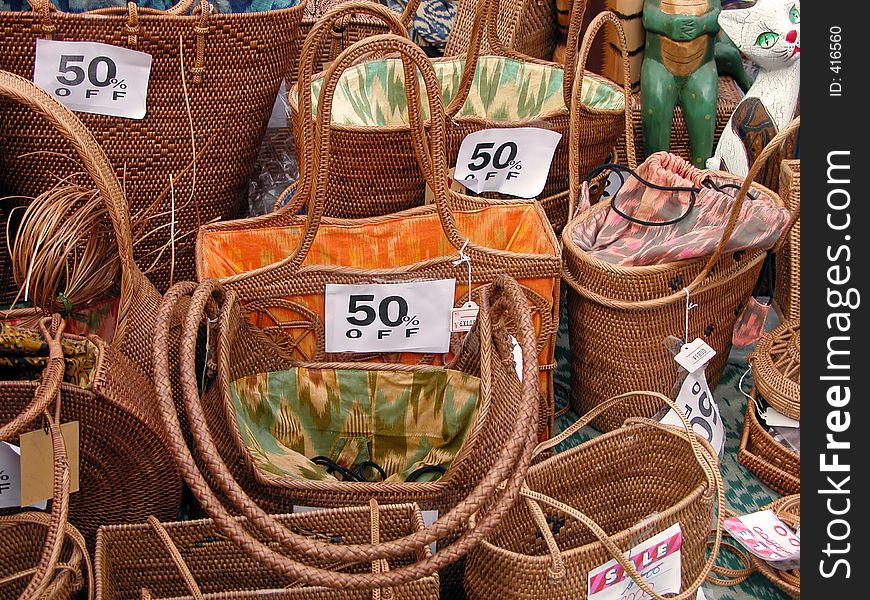Discounts on a wooden woman bags stall in a Japanese market. Discounts on a wooden woman bags stall in a Japanese market