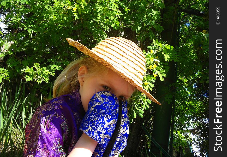 Child teasing, that maybe you can't see her, hiding behind her slippers. Child teasing, that maybe you can't see her, hiding behind her slippers.