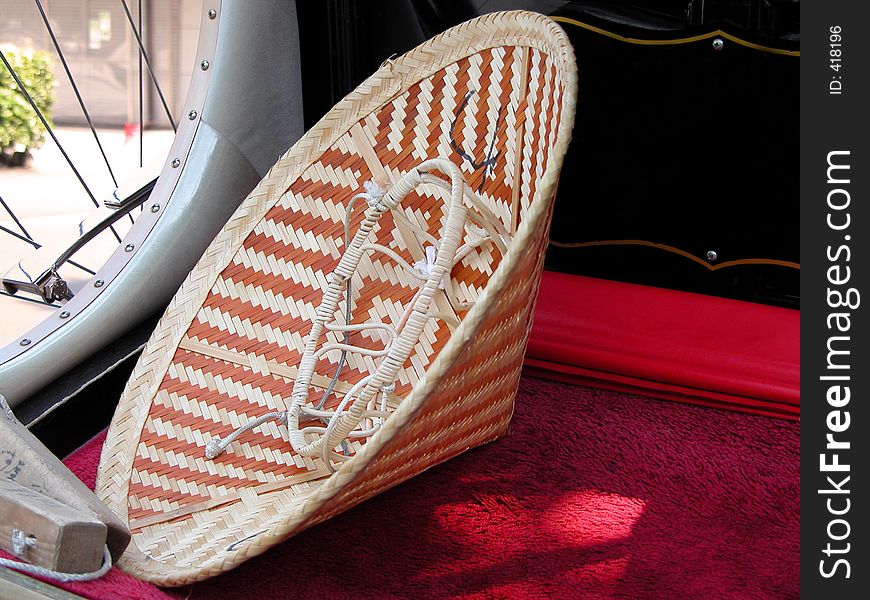 Chinese hat on a rickshaw bench-detail