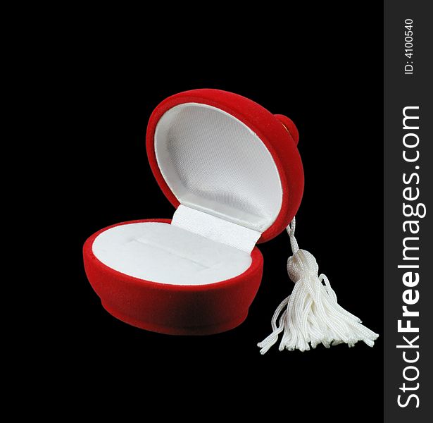 Casket under jewelry. The red and white satin on a black background