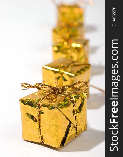 Golden wrapped gift boxes in a row. Golden wrapped gift boxes in a row