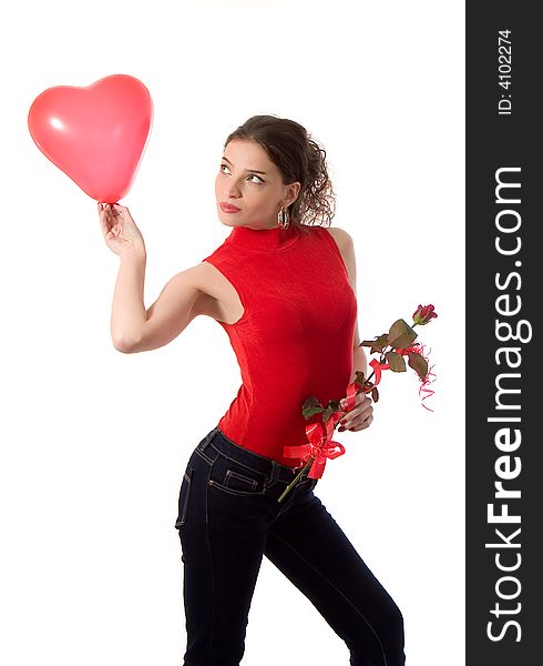 Attractive young woman holding heart shape balloon and a rose - love concept. Attractive young woman holding heart shape balloon and a rose - love concept