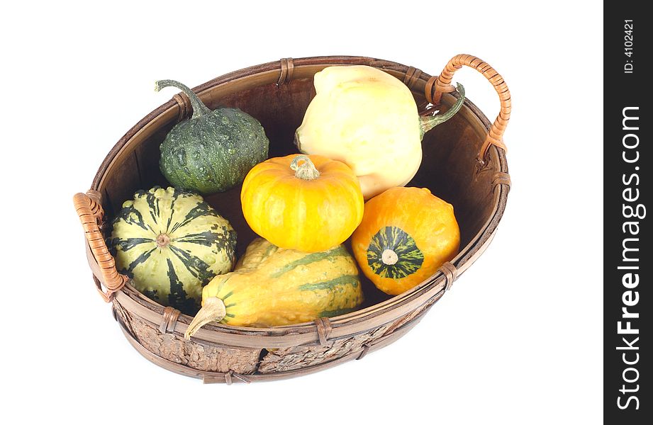 Mini pumpkins in a basket- yellow and green