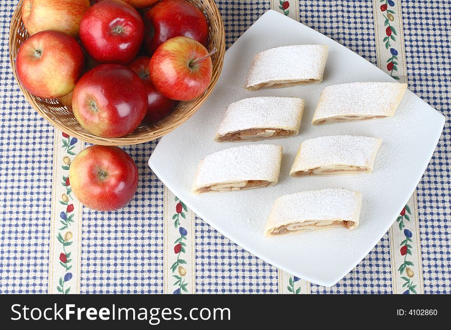 Still life with apple roll (strudel) and apples