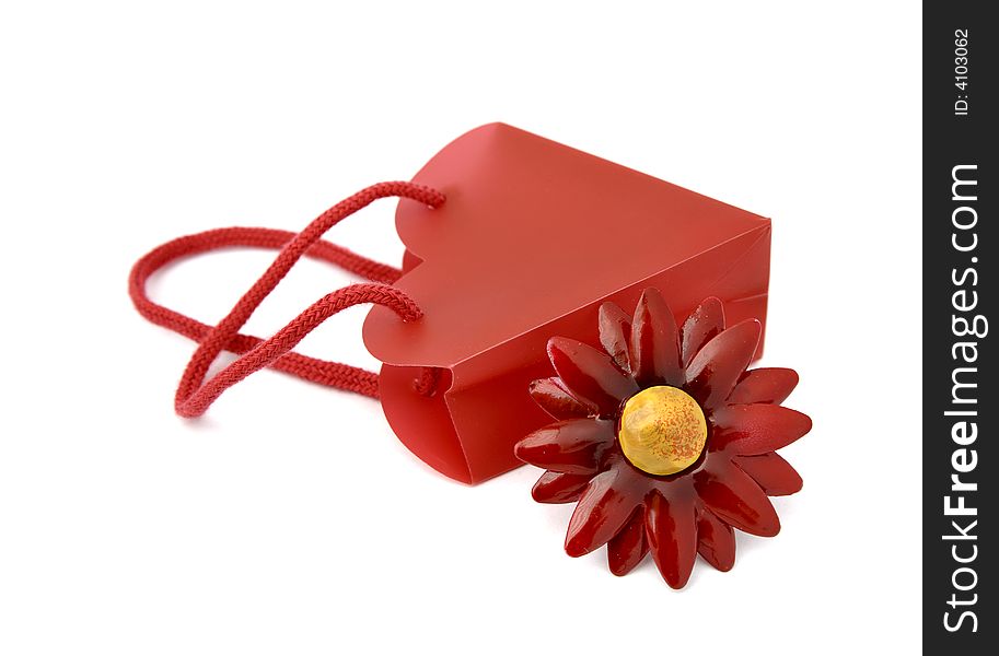 Gift consisting of red bag and flower metal