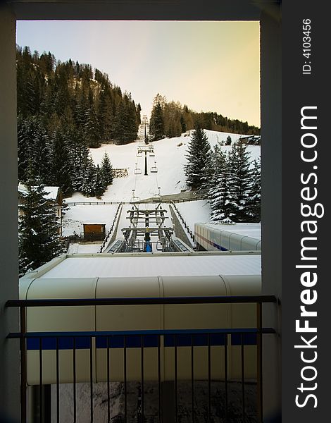 A hotel's chairlift in the snow taken from a hotel room balcony. A hotel's chairlift in the snow taken from a hotel room balcony