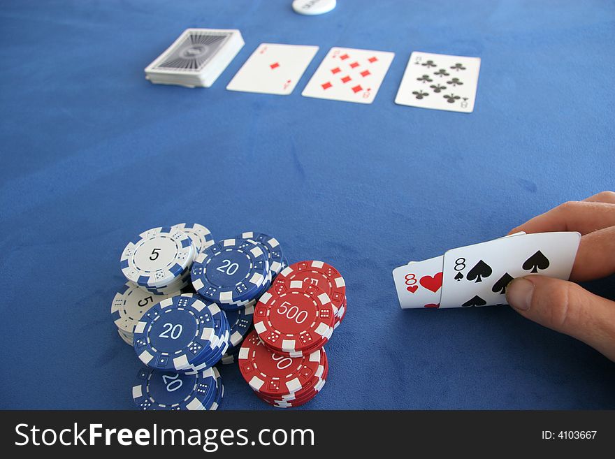 A poker player holds a pair of eights in his hand