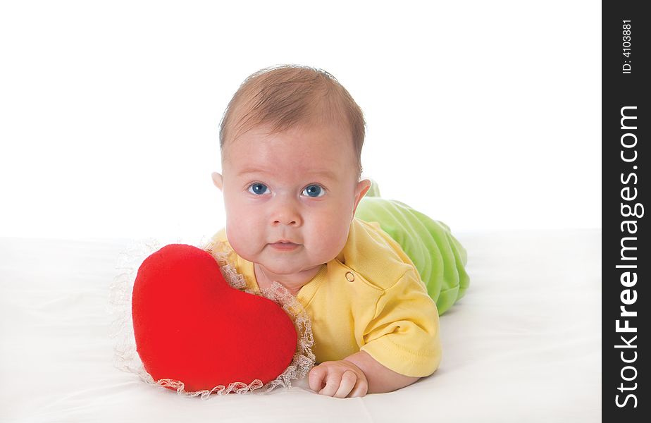 Baby with a soft toy in the form of heart over white