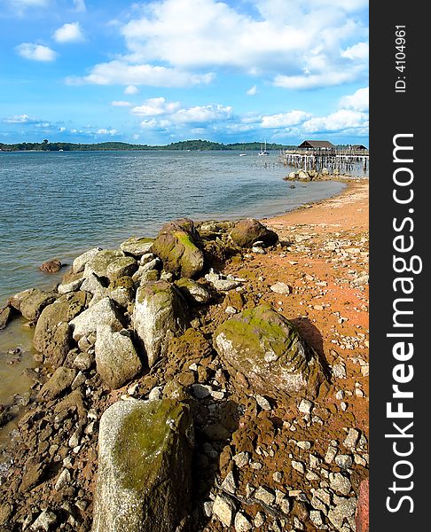 Rocky shore seen from boardwalk in a late afternoon sky