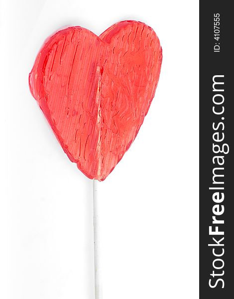 Heart-shaped lollipop on white. Heart-shaped lollipop on white