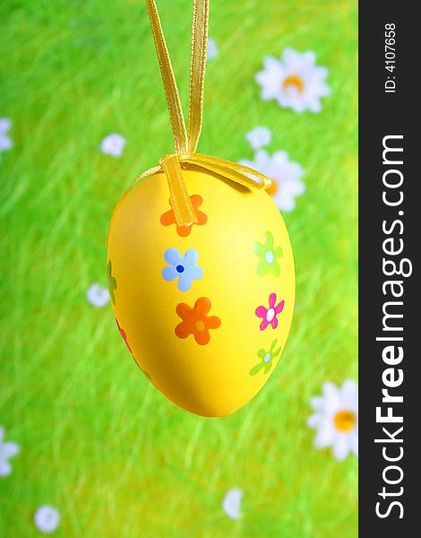 Pastel and colored Easter egg on green