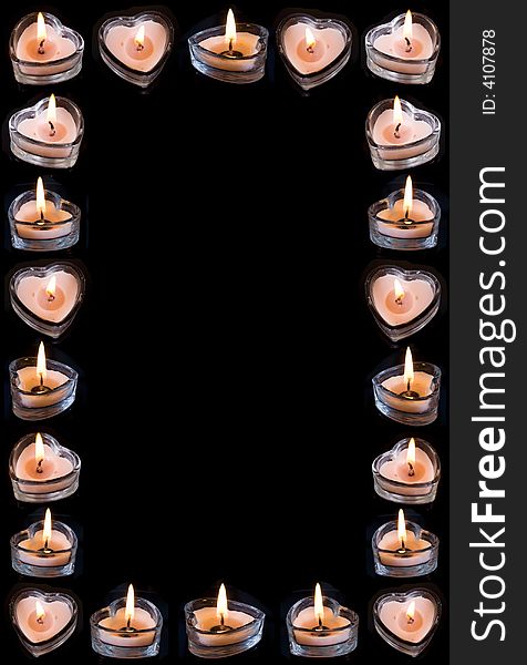 Frame from burning heart-candles on black background. Frame from burning heart-candles on black background