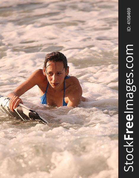 Bikini Girl with boogie board in the water. Bikini Girl with boogie board in the water