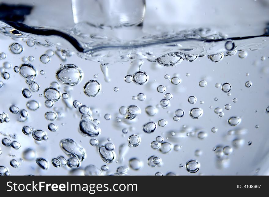 Flowing water and bubbles in glass. Flowing water and bubbles in glass