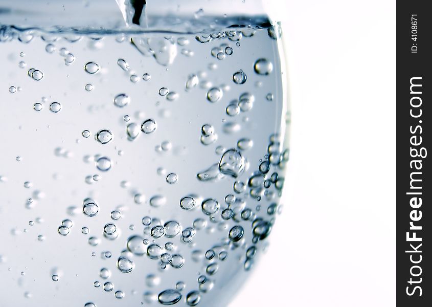 Flowing water and bubbles in glass. Flowing water and bubbles in glass