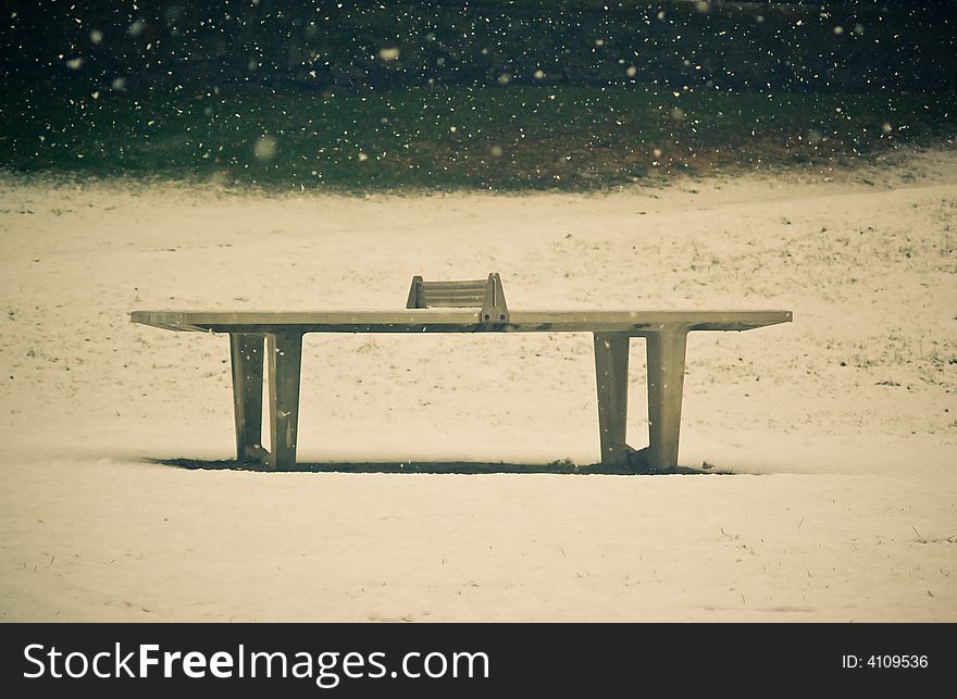 Tennis table as seen in winter time outdoors. Tennis table as seen in winter time outdoors