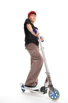 Boy Standing On A Scooter Royalty Free Stock Photography