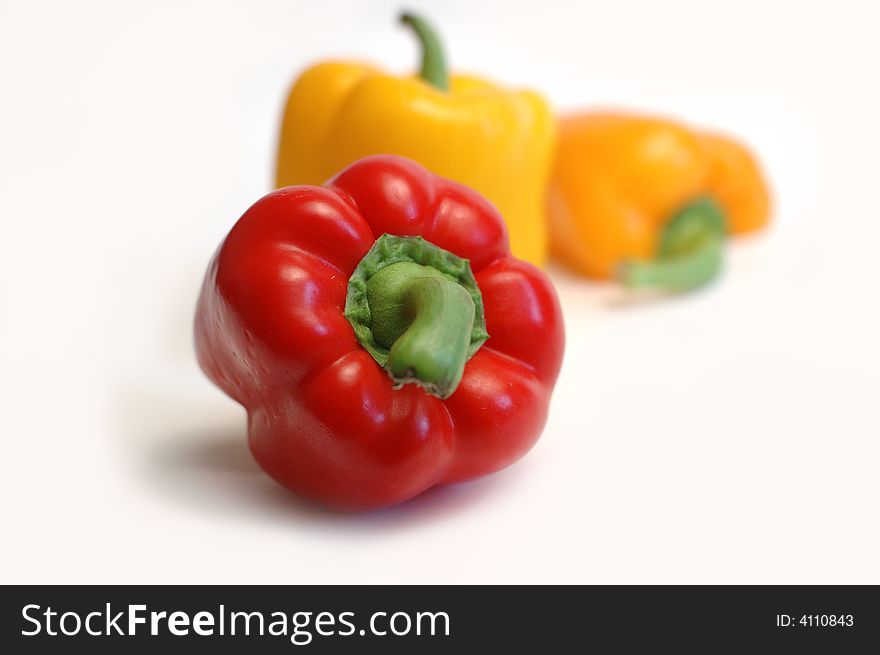 Red and yellow peppers isolated against white background