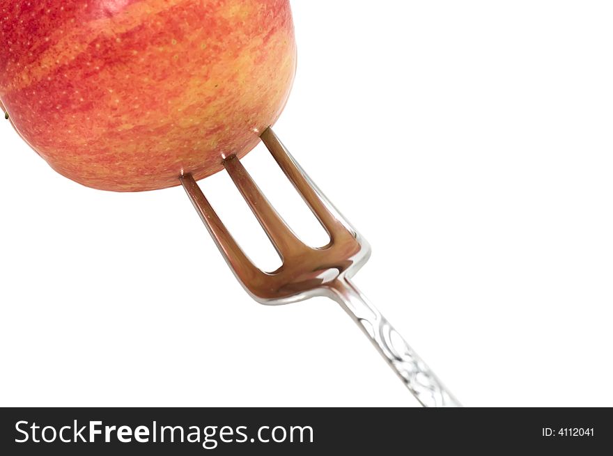 Fresh apple on silver fork isolated on white background. Fresh apple on silver fork isolated on white background