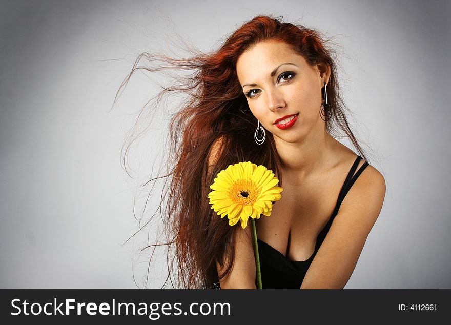 Beautiful lang-haired girl with yellow flower