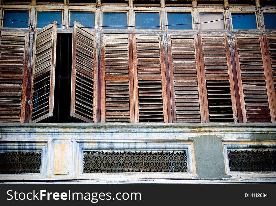 Wooden windows of a heritage building in Penang, Malaysia