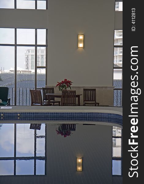 A nice indoor pool in a spa with a poinsettia on the table. A nice indoor pool in a spa with a poinsettia on the table